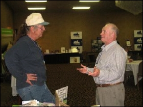 Bill Althouse, left, speaks with a convention attendee.